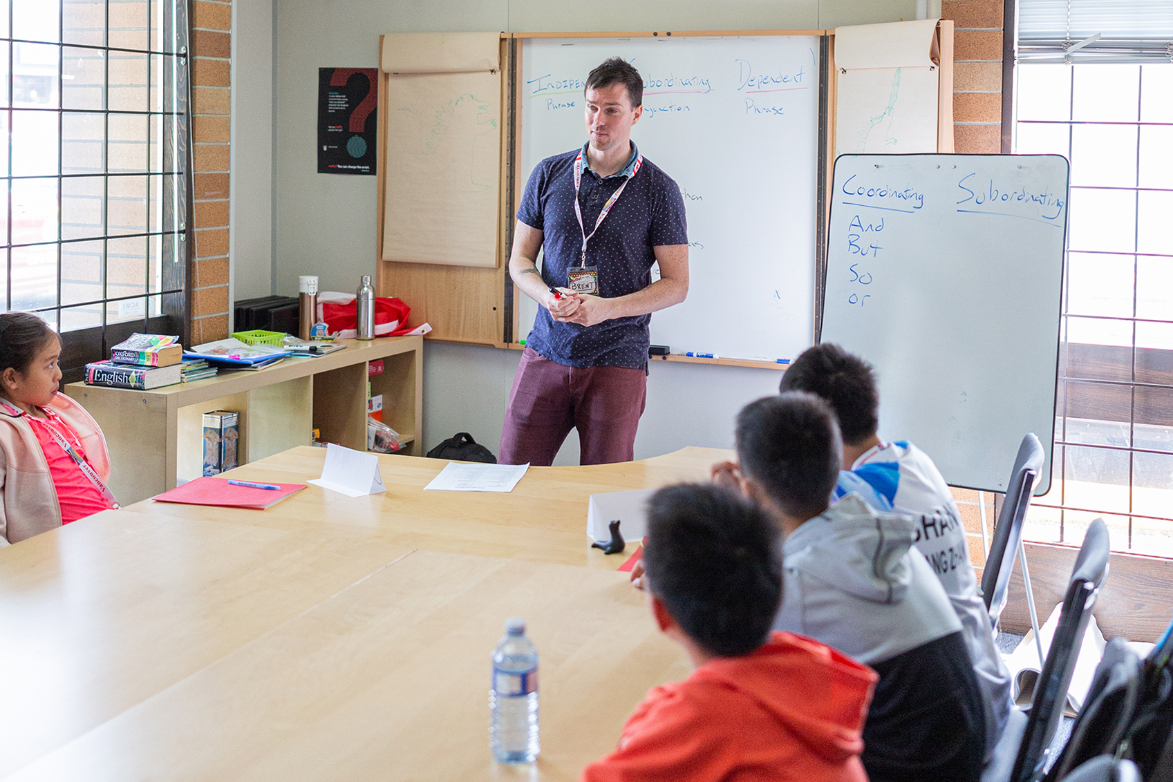 A teacher stands in front her students and teaches them about science and math.