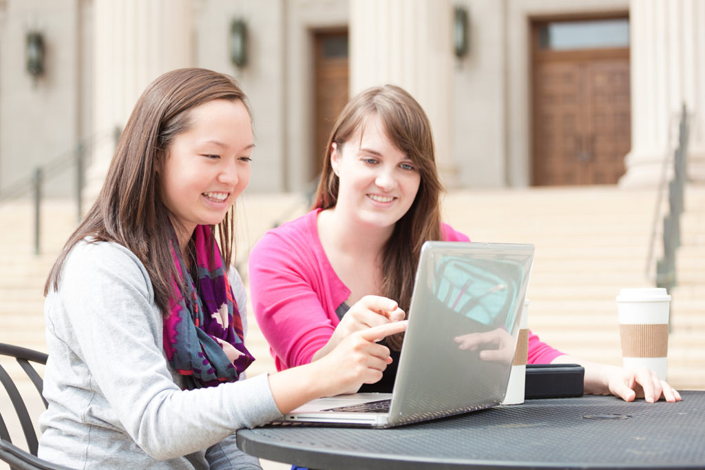 Students with Laptop at Outdoor Cafe in University Horizontal